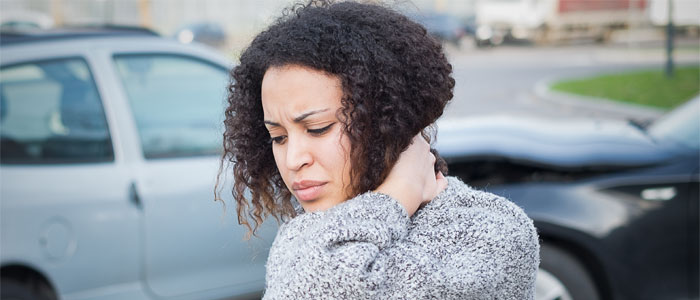 woman holding neck in pain after car accident